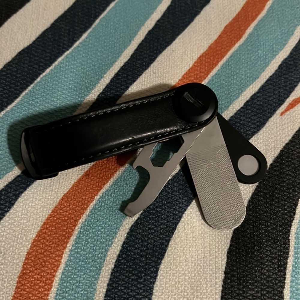 Black orbitkey with bottle opener, mirror and pin holder for sim tray/sim holder